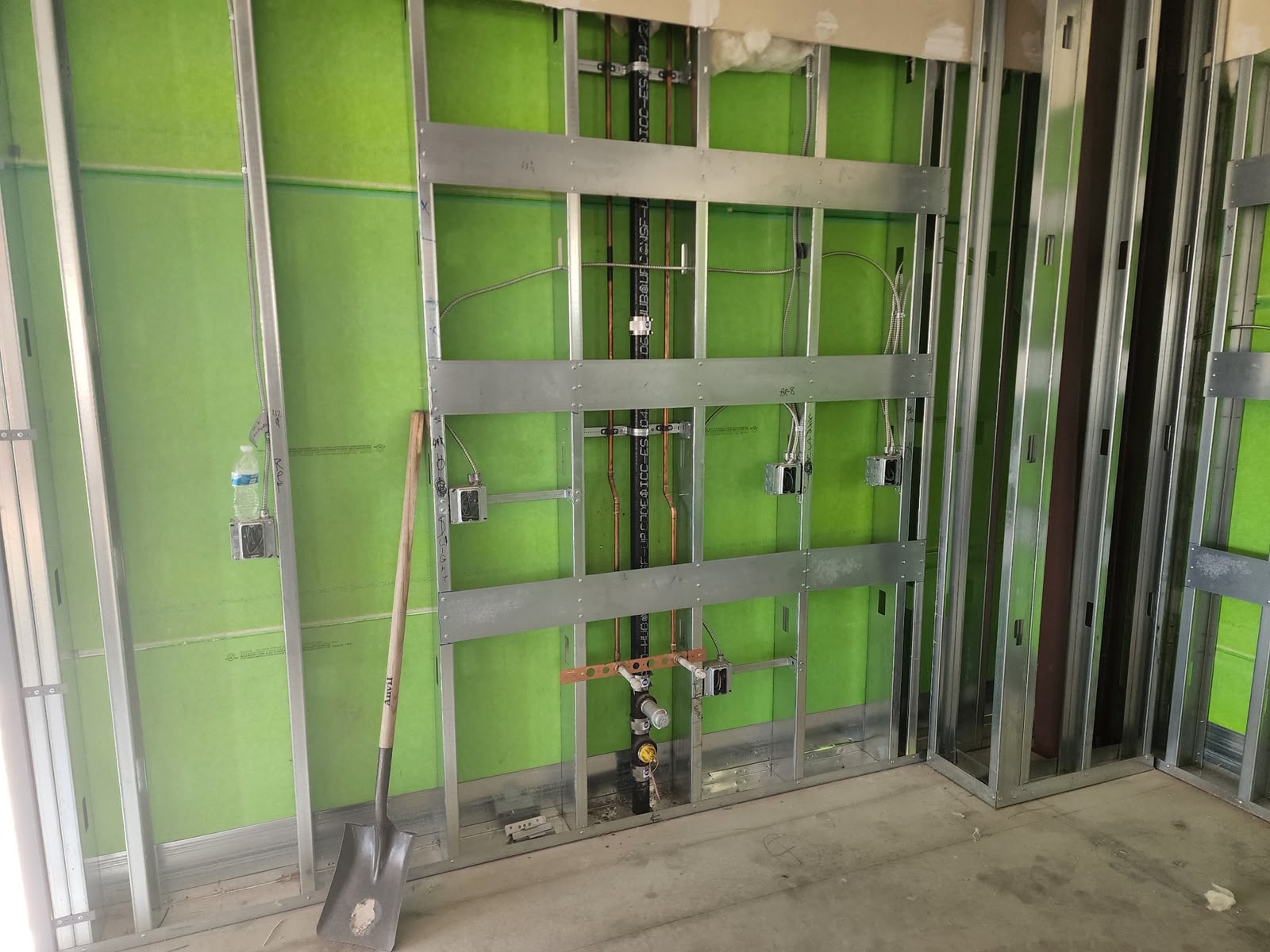 Copper water lines and electrical boxes framed
