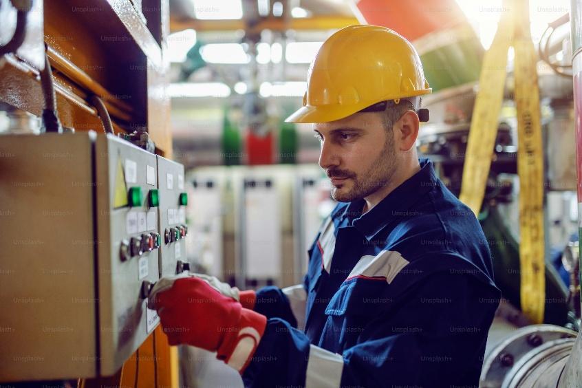 Professional electrician providing electrician services in Central Valley at an electrical panel.