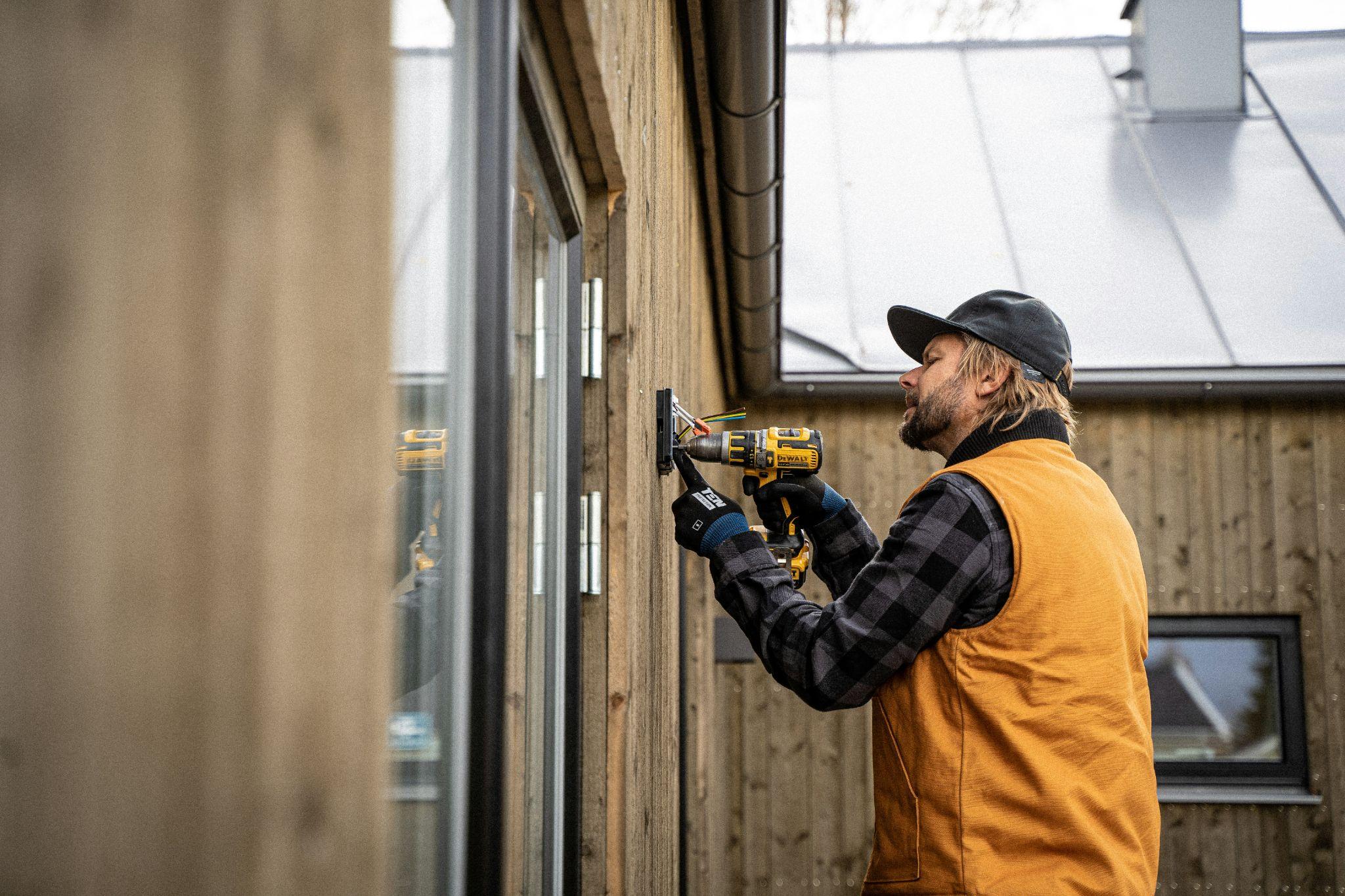 An electrician works on a building's electrical system for electrical fault diagnosis in Central Valley.