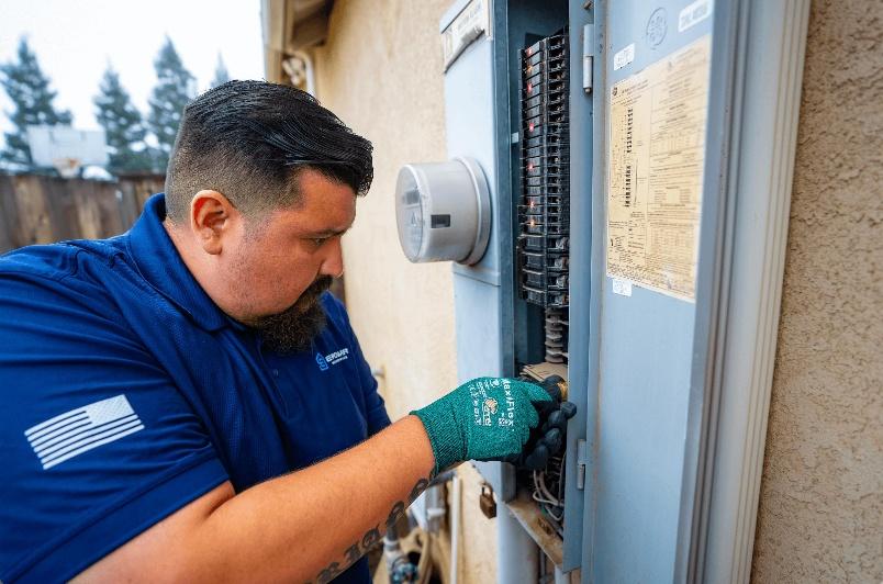 Residential electrician in Central Valley inspecting a home's electrical panel.