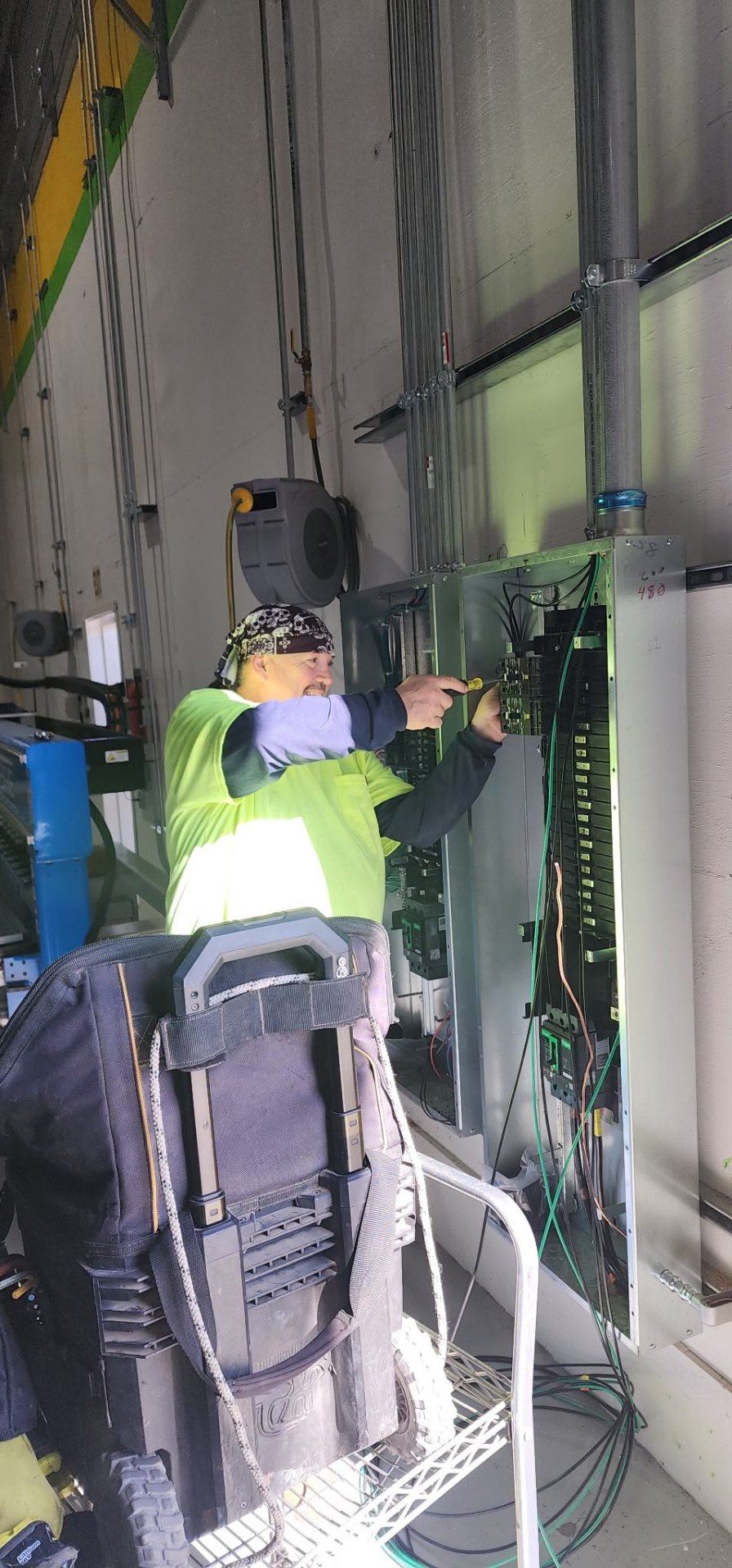 Jack Surabian Electric technician wiring a commercial panel