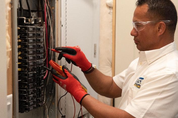 Electrician performing faulty circuit breaker replacement in Central Valley after inspecting a residential electrical panel