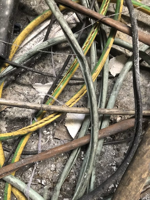 Close-up of exposed wiring showing signs of electrical damage