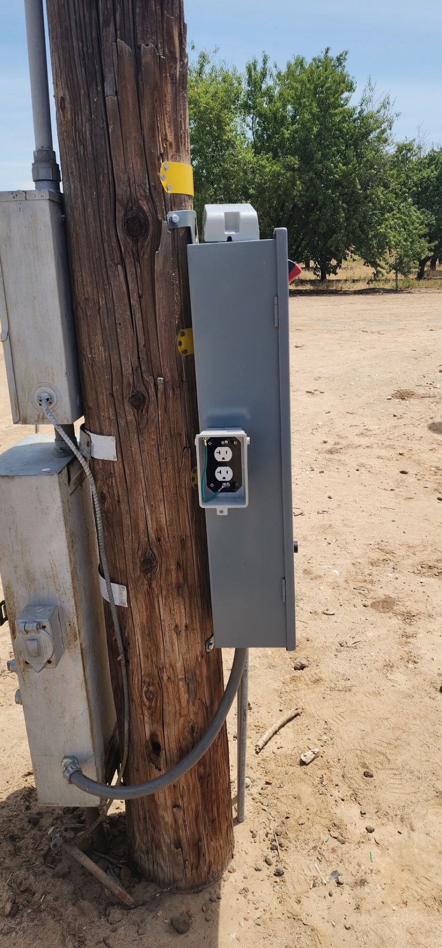 Weatherproof outlet on utility pole