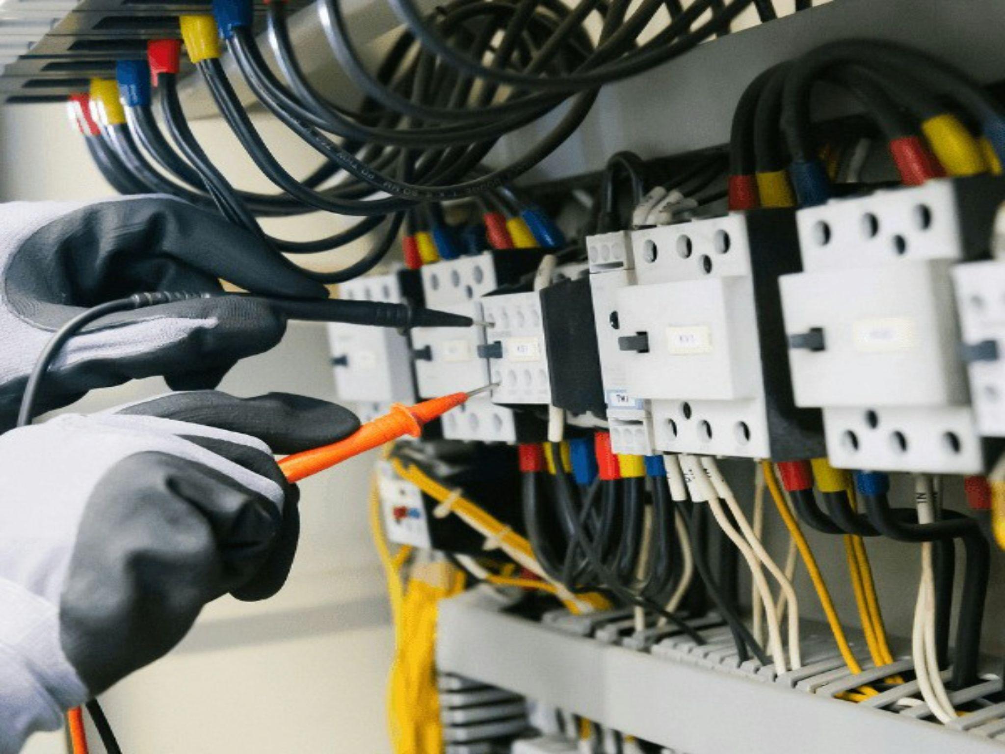 An electrician inspects an electrical panel during electrical problem diagnosis in Central Valley.