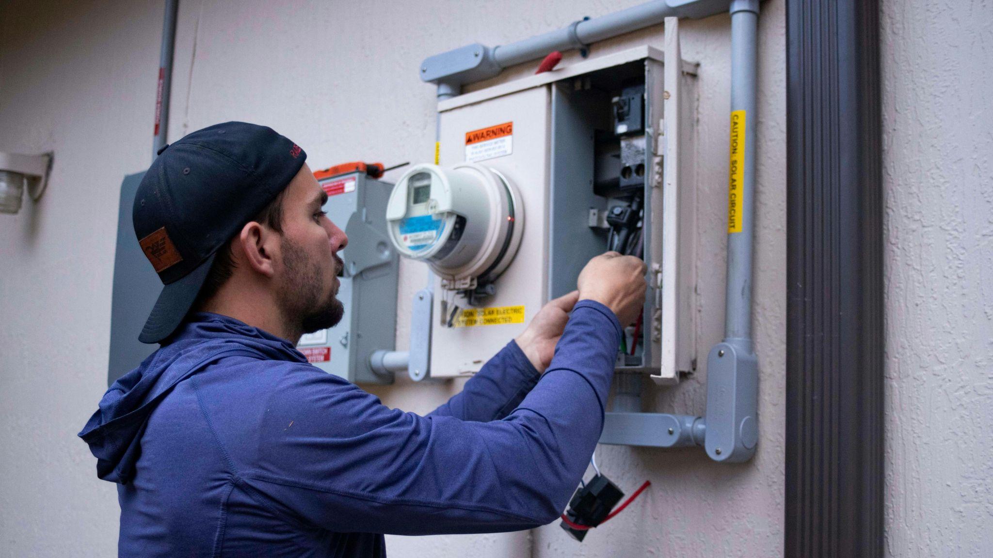 Electrician performing electrical troubleshooting in Central Valley on an electrical panel.